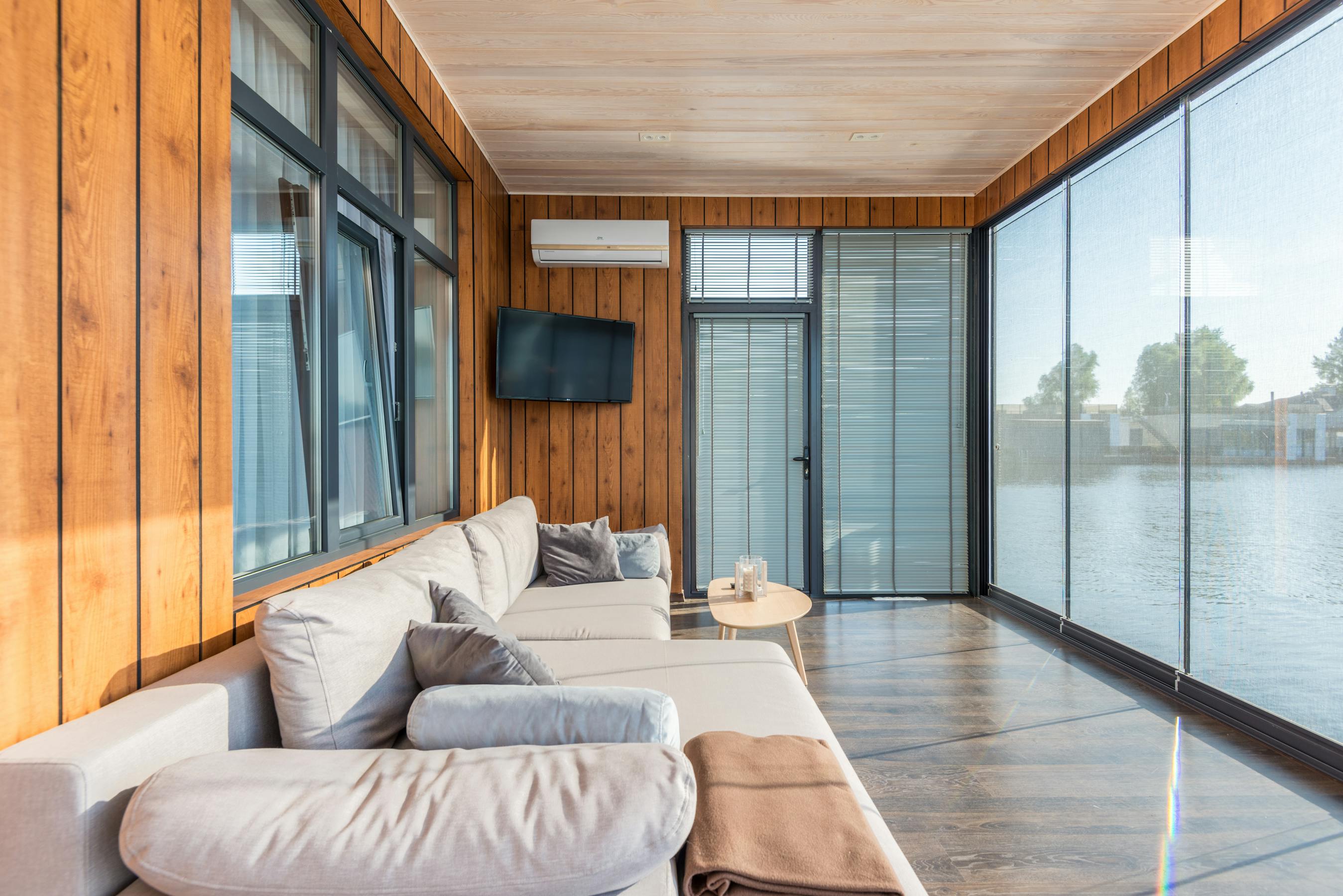 Motorized horizontal blinds in a modern South Florida living room with warm afternoon light